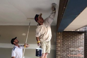 Two volunteer builders working on the roof at Nick's Journey House in Thurgoona NSW