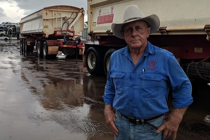 Bill Sullivan wears a big hat and stands by a truck